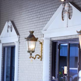 A charming entrance featuring decorative lanterns and classic architectural elements.