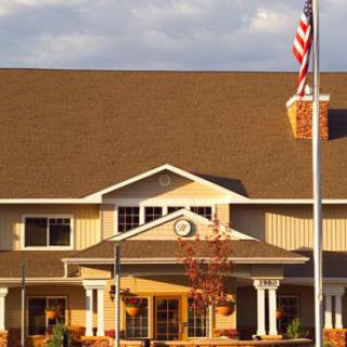 A welcoming residential building featuring a front entrance and an American flag.