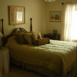 A cozy bedroom with elegant furniture and soft lighting.