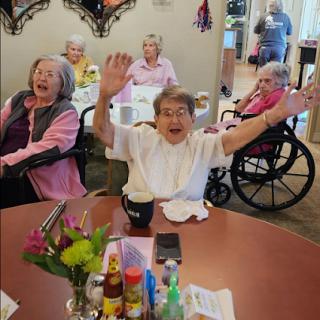A joyful moment among residents at a care facility, celebrating life and companionship.