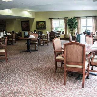 A spacious indoor dining area with neatly arranged tables and chairs.