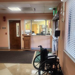 A view of a healthcare facility's waiting area featuring a wheelchair.