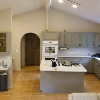 A modern kitchen with an island counter and built-in appliances.