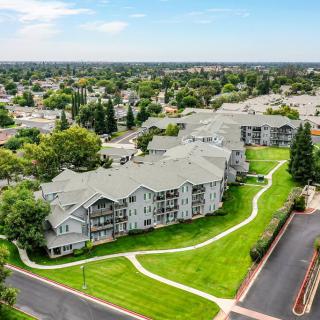Aerial view of a residential apartment complex with green spaces and pathways.