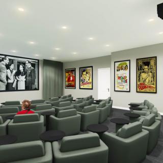 A stylish home theater room featuring comfortable seating and classic movie posters.