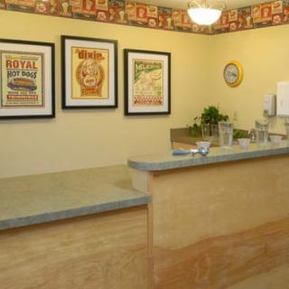 A welcoming reception area with framed vintage posters and a modern counter.