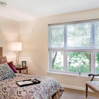 A cozy bedroom with elegant decor and ample natural light.