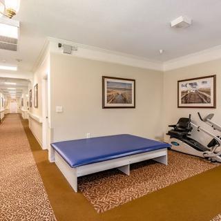 A small gym area with exercise equipment and a stretching mat.