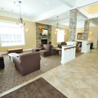 A modern lobby featuring comfortable seating and a fireplace.