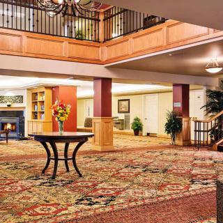 A luxurious hotel lobby with elegant furnishings and a richly patterned carpet.