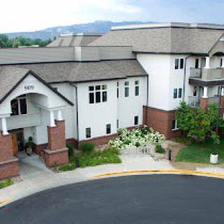 A modern residential building with landscaped surroundings.