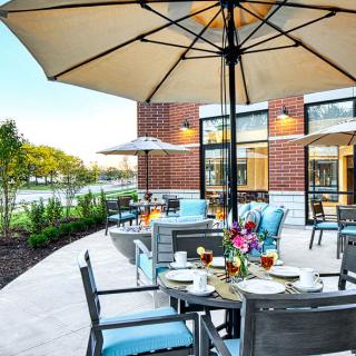 A charming outdoor dining area with umbrellas and neatly set tables, perfect for relaxing in a pleasant atmosphere.