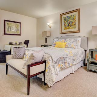 A cozy bedroom with elegant decor and comfortable furnishings.