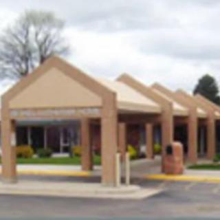 A building with a series of triangular canopies at the entrance.