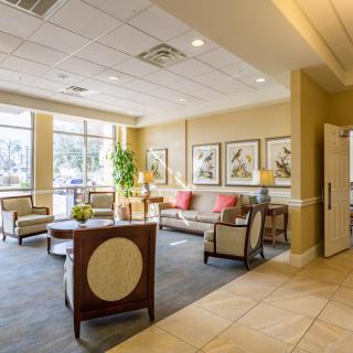 A well-lit lobby area with comfortable seating and decorative artwork on the walls.