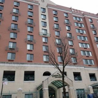 A multi-story hotel building featuring multiple windows and a welcoming entrance.
