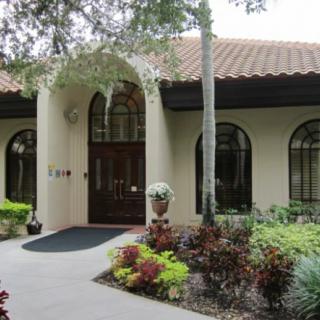 A charming house with arched windows and a well-maintained front garden.