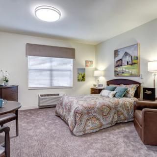 A cozy and modern bedroom featuring a comfortable bed, stylish furniture, and soft lighting.