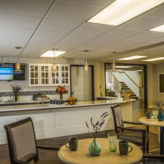 A modern lobby with a reception desk and comfortable seating area.