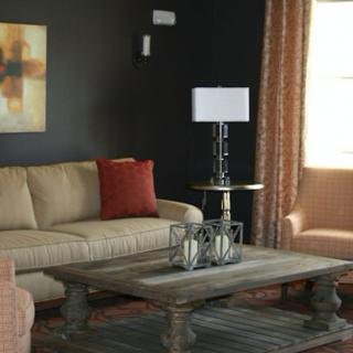 A cozy and stylish living room with a beige sofa, a wooden coffee table, and a modern lamp.