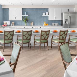 A modern kitchen and dining area with stylish chairs and elegant table settings.