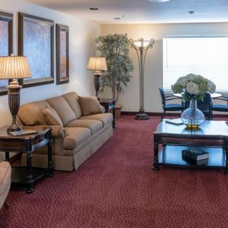 A cozy living room featuring a comfortable sofa, coffee table, and elegant lighting.