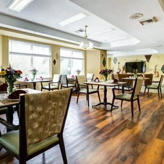 A bright and elegant dining area with neatly arranged tables and chairs.