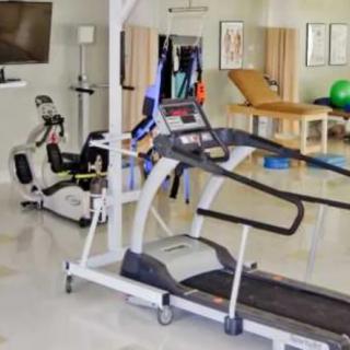 A well-equipped indoor gym with a treadmill and exercise bike.