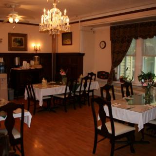 A cozy dining room with elegant furnishings and warm lighting.