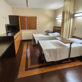 A cozy hotel room featuring two beds, wooden furniture, and modern decor.