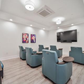 A modern home theater setup with recliner chairs and a large screen.