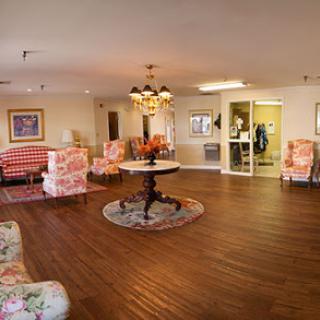 A cozy and inviting living room space with floral patterned furniture and warm lighting.