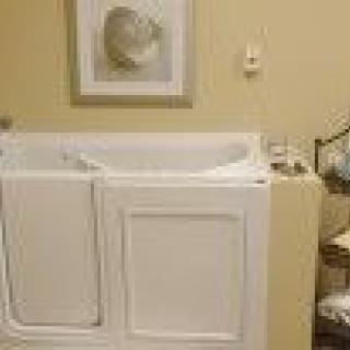 A bathroom featuring a walk-in bathtub designed for accessibility and safety.