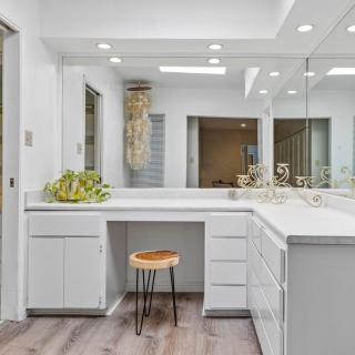 A modern bathroom vanity with bright lighting and minimalist design.