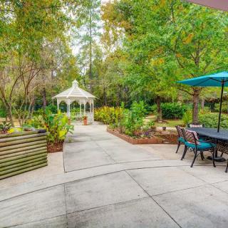 A tranquil garden with a gazebo and outdoor seating area.