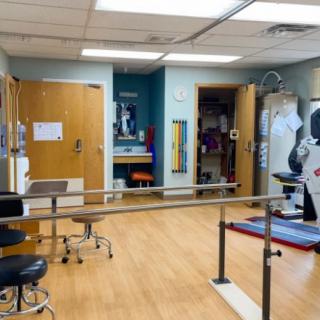 A physical therapy room equipped with exercise and rehabilitation equipment.