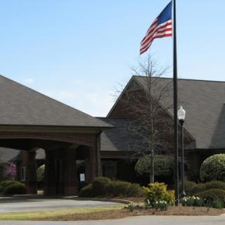 Entrance to a building with an American flag waving in front.