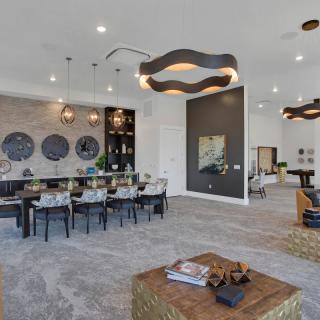A spacious modern living and dining area with contemporary decor and unique lighting fixtures.