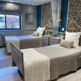 A stylishly designed bedroom featuring two beds with elegant decor and modern furnishings.