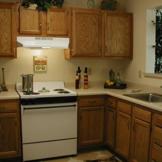 A cozy kitchen with wooden cabinets and modern appliances.