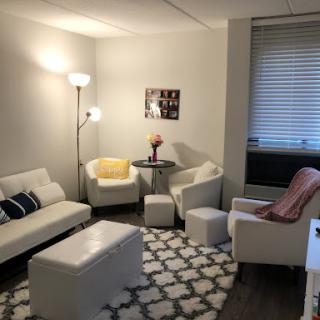A cozy and modern living room setup with comfortable seating and bright lighting.