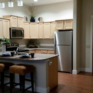 A modern kitchen with wooden cabinets and stainless steel appliances.