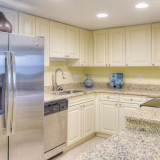 A modern kitchen with stainless steel appliances and granite countertops.
