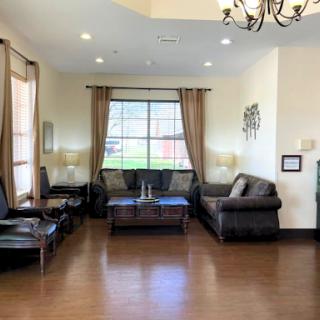A cozy and well-lit living room featuring leather furniture and elegant decor.
