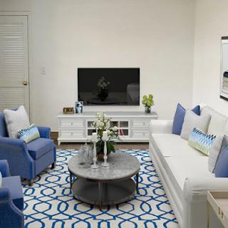 A stylish modern living room featuring a blue and white color scheme with comfortable seating and contemporary decor.