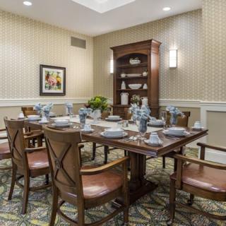 A well-appointed dining room with a set table and classic furnishings.