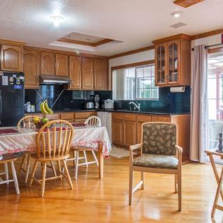 A cozy kitchen and dining area with wooden cabinets and a table set for dining.