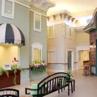 A uniquely designed interior space resembling an outdoor street with benches and decorative facades.