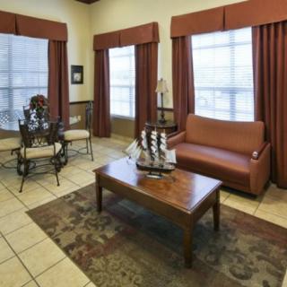 Cozy living room with a sofa, coffee table, and dining area.