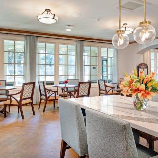 A beautifully designed dining room with elegant furniture and natural light.